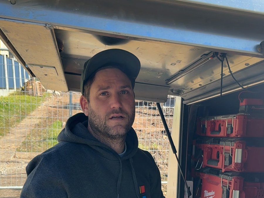 A worker standing at his truck toolbox