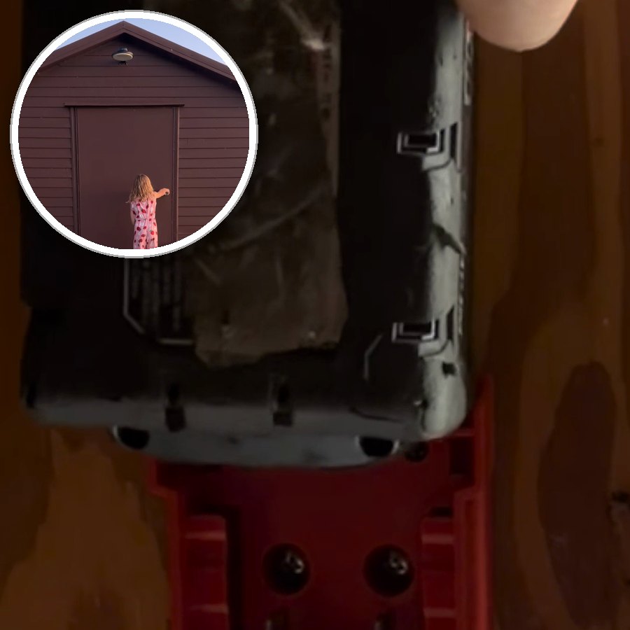 A battery going onto the LockLite adapter on a backyard shed wall