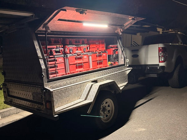 Toolbox on a truck bed lit up by a LockLite at night